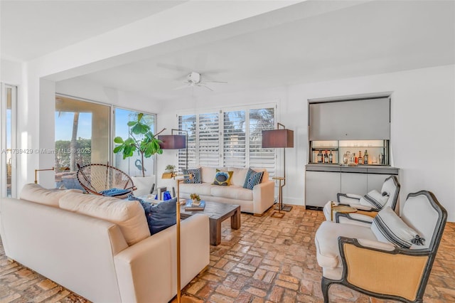 living room with a wealth of natural light and ceiling fan