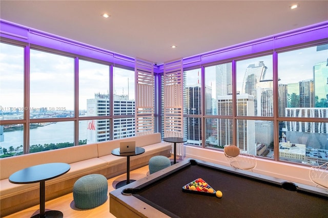 playroom with a water view, pool table, and plenty of natural light