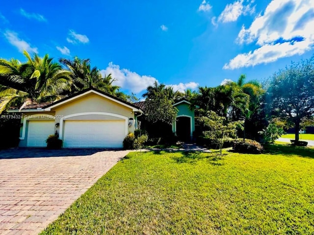 view of front of home with a garage and a front lawn