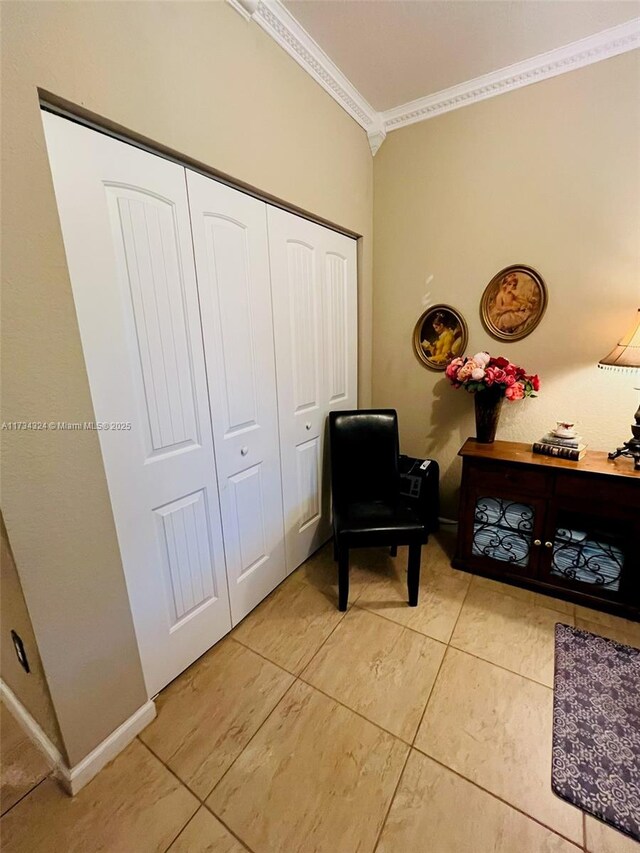 living area with tile patterned flooring and ornamental molding