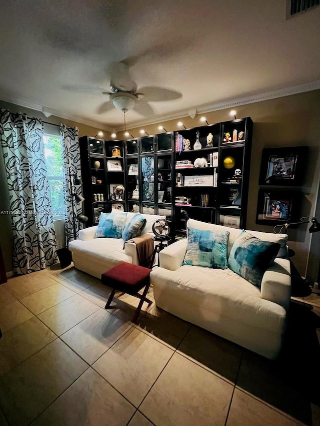 sitting room with crown molding, ceiling fan, tile patterned flooring, and a textured ceiling