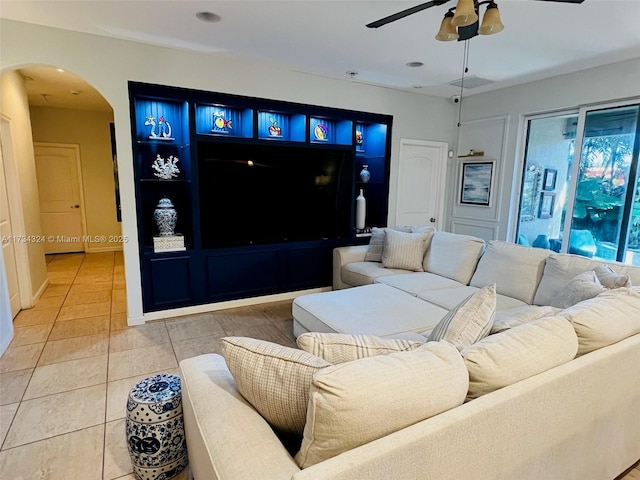 tiled living room with ceiling fan