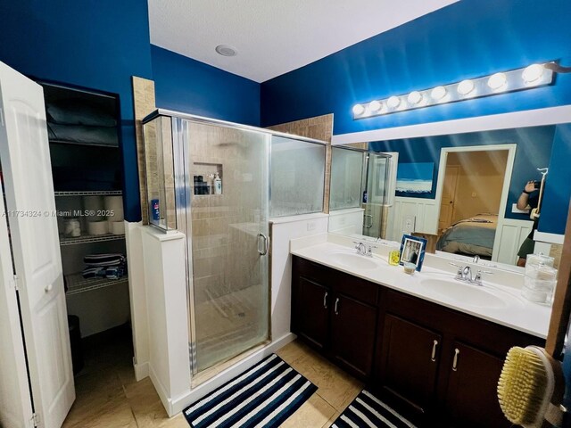 bathroom featuring an enclosed shower and a textured ceiling