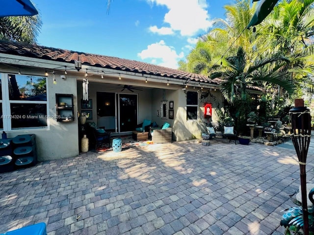 view of patio / terrace with an outdoor living space and ceiling fan