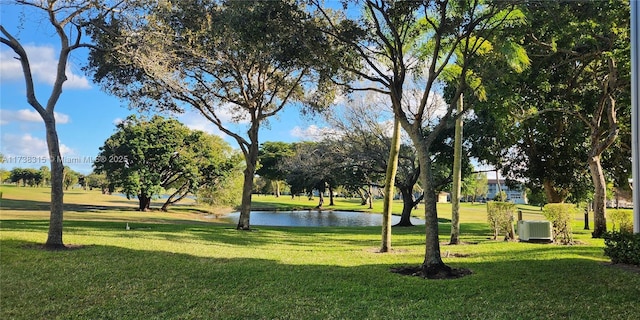 view of community featuring a yard and a water view