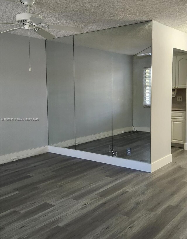 spare room with wood-type flooring and a textured ceiling