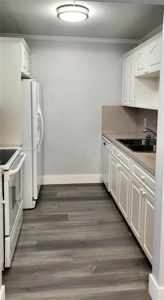 kitchen with sink, white appliances, white cabinetry, dark hardwood / wood-style floors, and ornamental molding