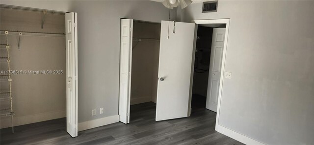 unfurnished bedroom with multiple closets, a textured ceiling, and light hardwood / wood-style flooring