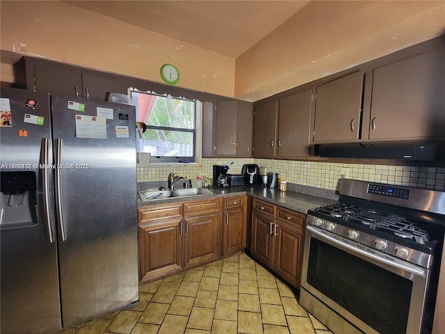 kitchen with tasteful backsplash, appliances with stainless steel finishes, sink, and light tile patterned floors