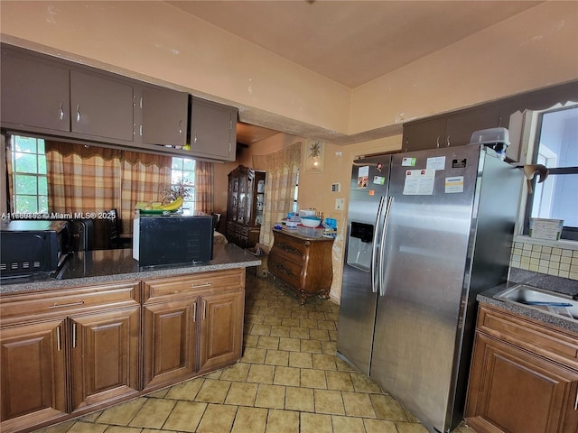 kitchen with tasteful backsplash and stainless steel fridge