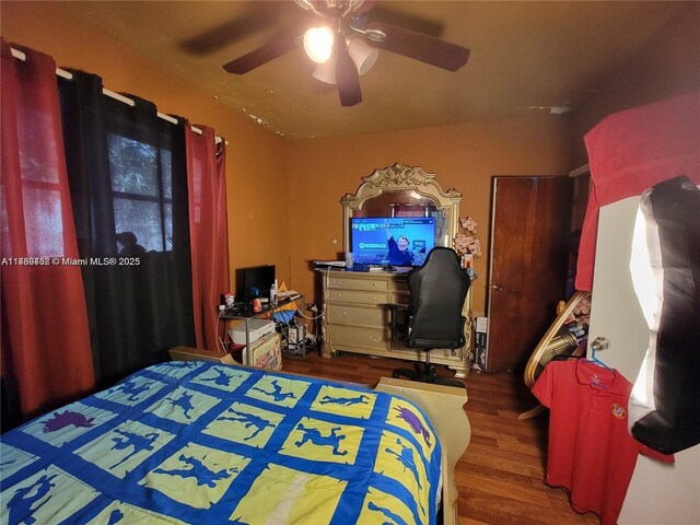 bedroom with hardwood / wood-style floors and ceiling fan