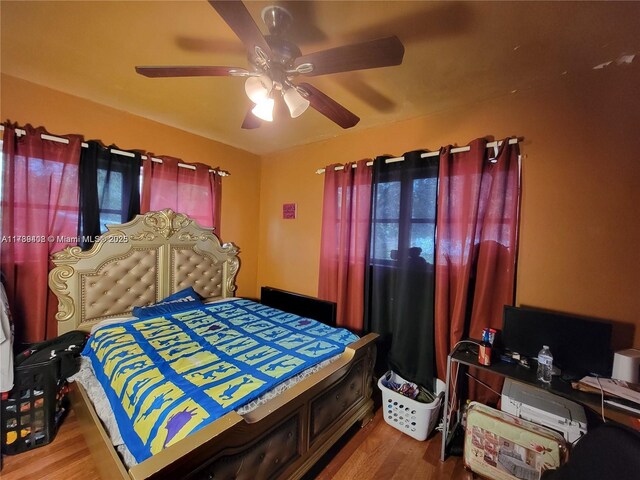 bedroom with hardwood / wood-style floors and ceiling fan