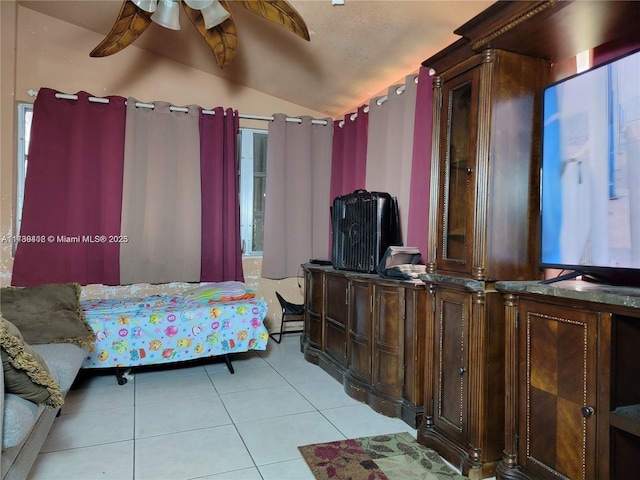 tiled bedroom featuring lofted ceiling