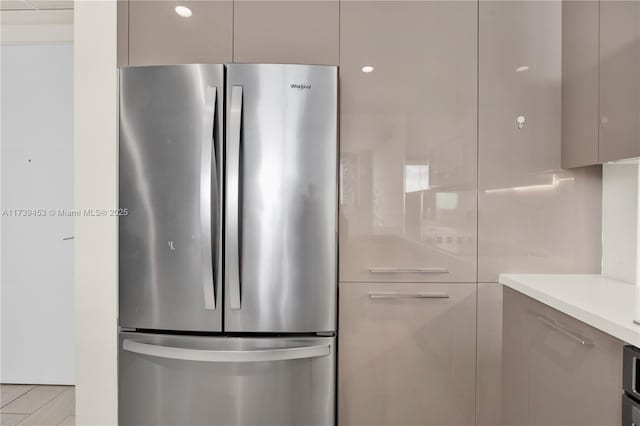 kitchen featuring stainless steel fridge and gray cabinetry