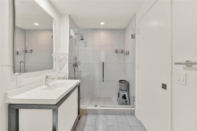 bathroom featuring vanity and a shower with shower door