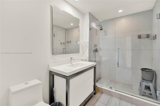 bathroom featuring vanity, toilet, and walk in shower