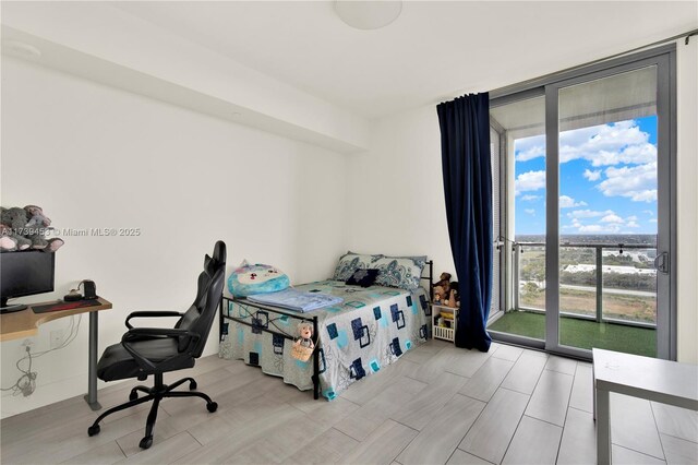 bedroom with floor to ceiling windows and access to outside