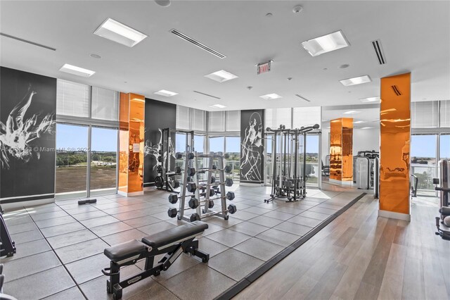 exercise room with expansive windows and light wood-type flooring