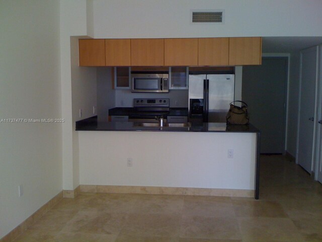 kitchen with stainless steel appliances and kitchen peninsula