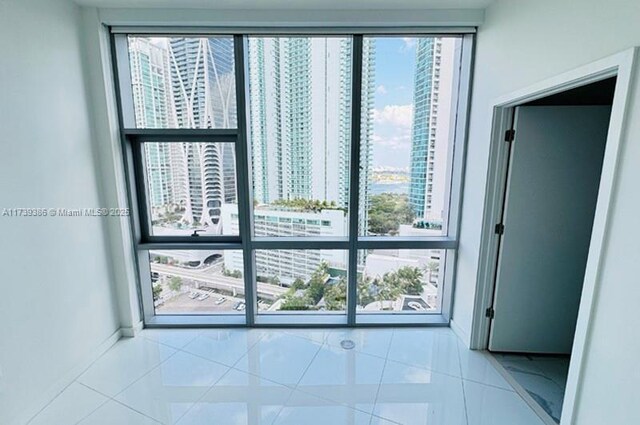 unfurnished room featuring tile patterned floors and a wealth of natural light