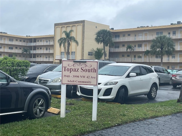 view of car parking featuring a lawn