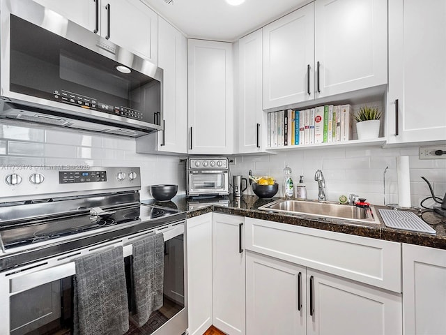 kitchen featuring white cabinetry, appliances with stainless steel finishes, sink, and tasteful backsplash