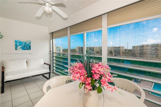 sunroom / solarium featuring ceiling fan