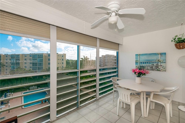 sunroom / solarium featuring ceiling fan