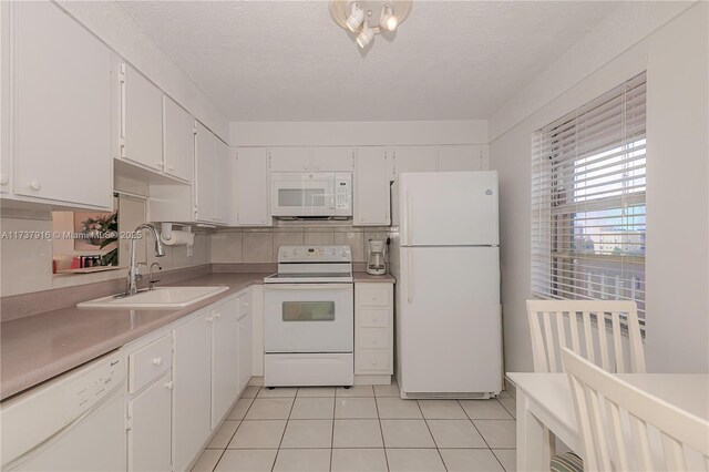 kitchen featuring white cabinetry, white appliances, light tile patterned flooring, and decorative backsplash