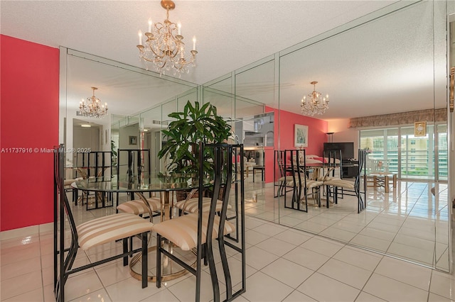 dining space featuring a textured ceiling, tile patterned floors, and a chandelier