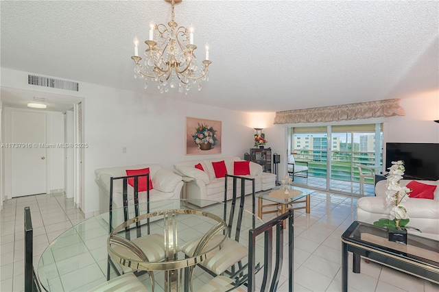 living room with light tile patterned floors, visible vents, a textured ceiling, and an inviting chandelier