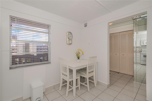 dining area with light tile patterned flooring