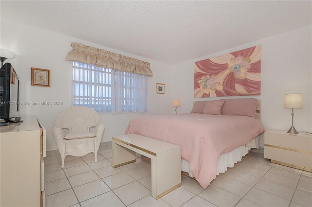 tiled bedroom with a textured ceiling