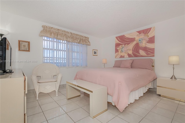 bedroom with light tile patterned flooring and a textured ceiling