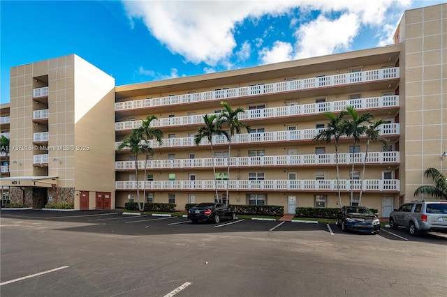 view of building exterior with uncovered parking