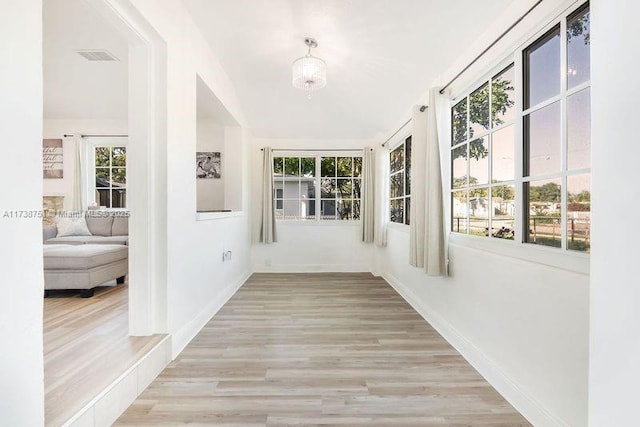 unfurnished sunroom with visible vents