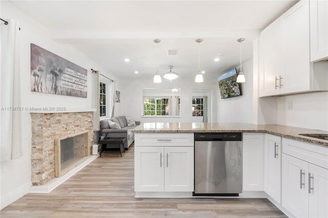 kitchen featuring dishwasher, kitchen peninsula, hanging light fixtures, and white cabinets