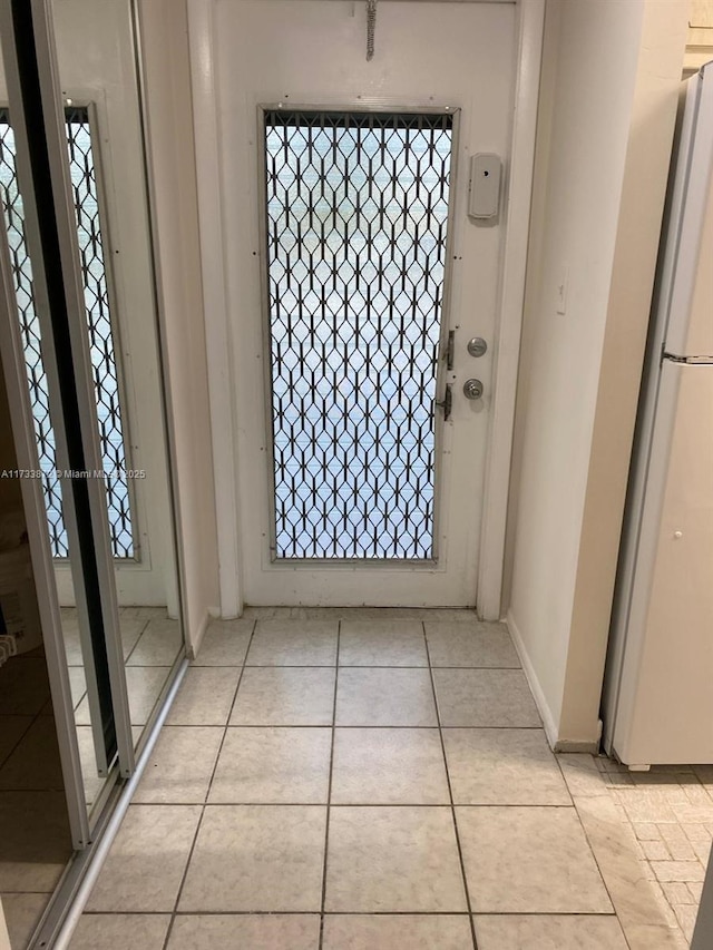 foyer entrance with light tile patterned floors