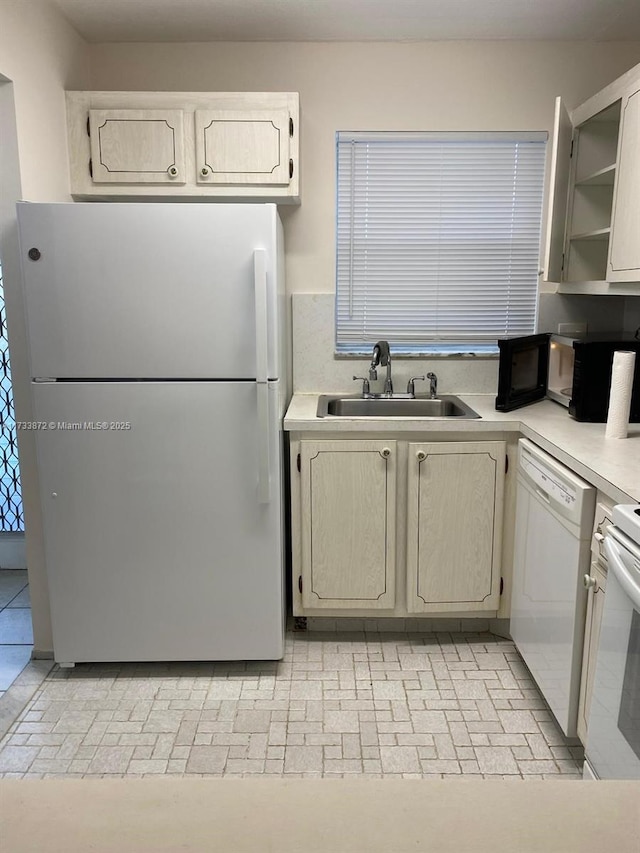 kitchen with sink and white appliances