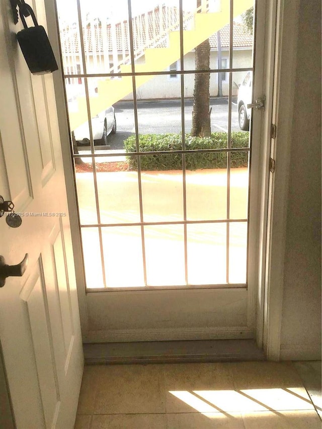 doorway featuring light tile patterned flooring