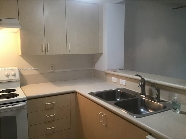 kitchen with white electric stove, light countertops, under cabinet range hood, and a sink