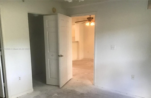 spare room featuring a ceiling fan and concrete flooring