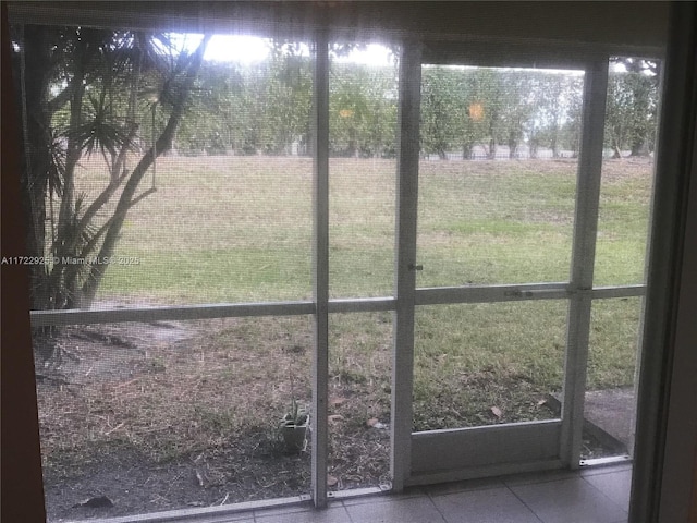 doorway to outside featuring tile patterned flooring