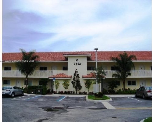 view of property featuring uncovered parking