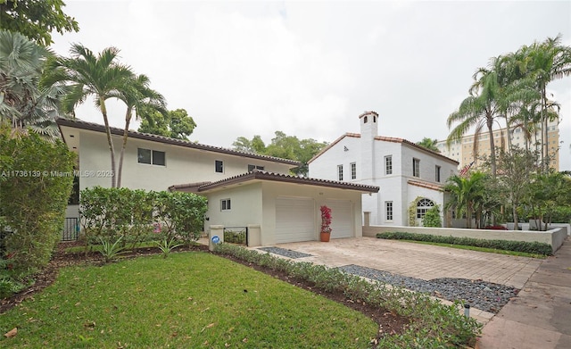 view of front of house with a garage and a front yard