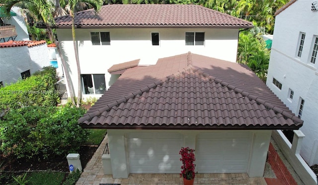 rear view of property with a garage