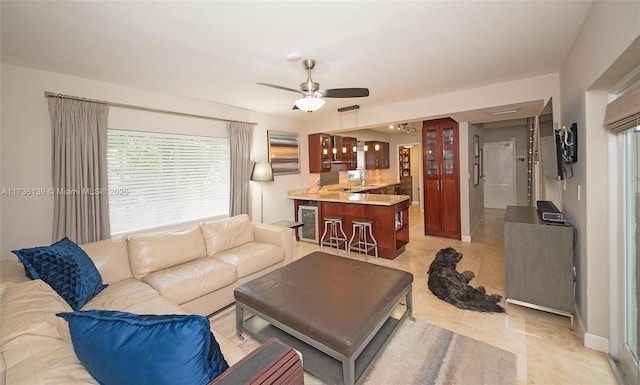 living room featuring sink, wine cooler, and ceiling fan