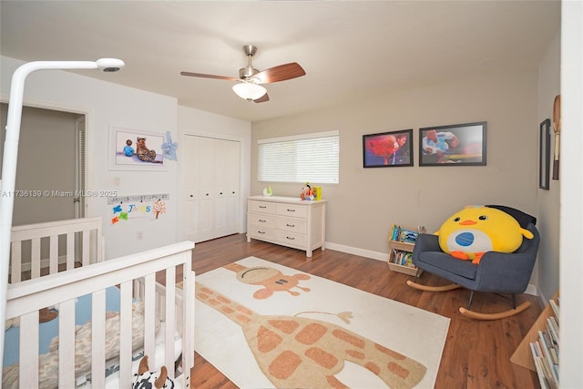 bedroom featuring ceiling fan, dark hardwood / wood-style flooring, and a closet