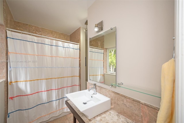 bathroom with sink and curtained shower