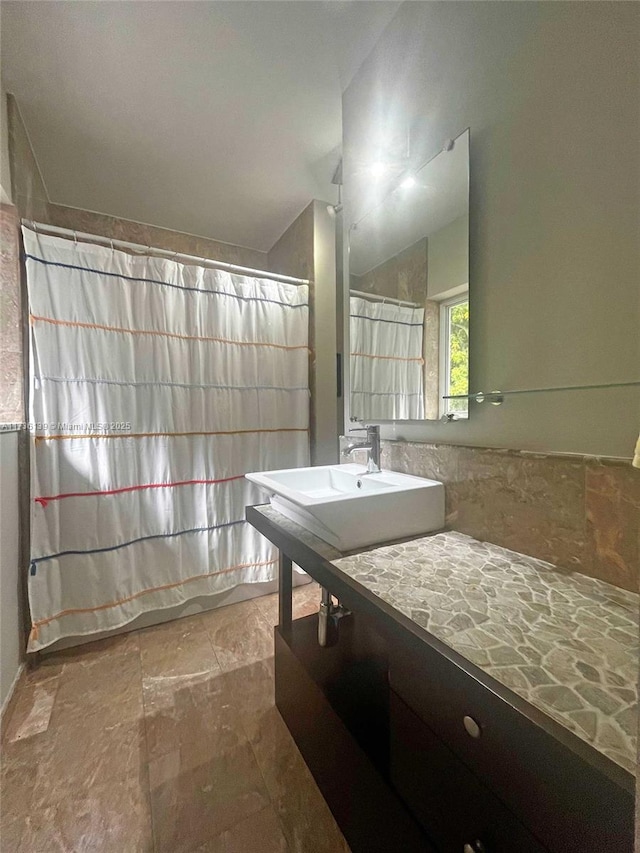 bathroom with lofted ceiling and sink